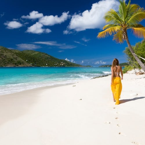 Woman walking on a Caribbean beach